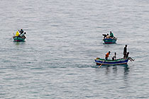 people in small fishing boats at sunrise