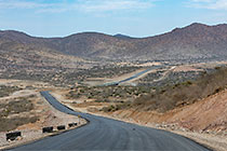 new tar road & bridge through arid hills