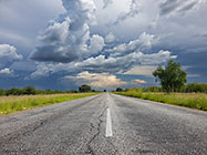 storm clouds over straight road