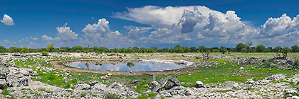 waterhole with cumulus clouds