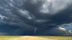 lightning & stormy clouds above road
