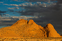 Spitzkoppe mountain under clouds at sunset
