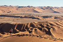 Don & Sandy climbing sand dunes at sunrise