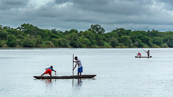fishermen on boats on river