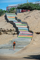 Roberta walking down colorful stairs