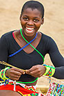 Zulu village : girl weaving mat