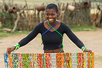 Zulu village : girl weaving mat