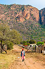woman walking in village street + amphitheatre