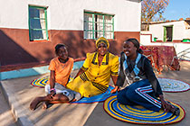 woman (Martha Mosima) sitting with children near pedi home