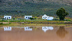 staff houses reflecting in dam