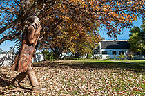 wooden sculpture, old man walking in garden