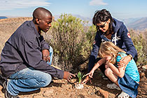 Blessing, Lisa & Jacqui looking at plant