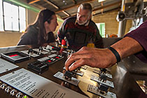 olive oil processing : hand on control panel + Petra & Fernand